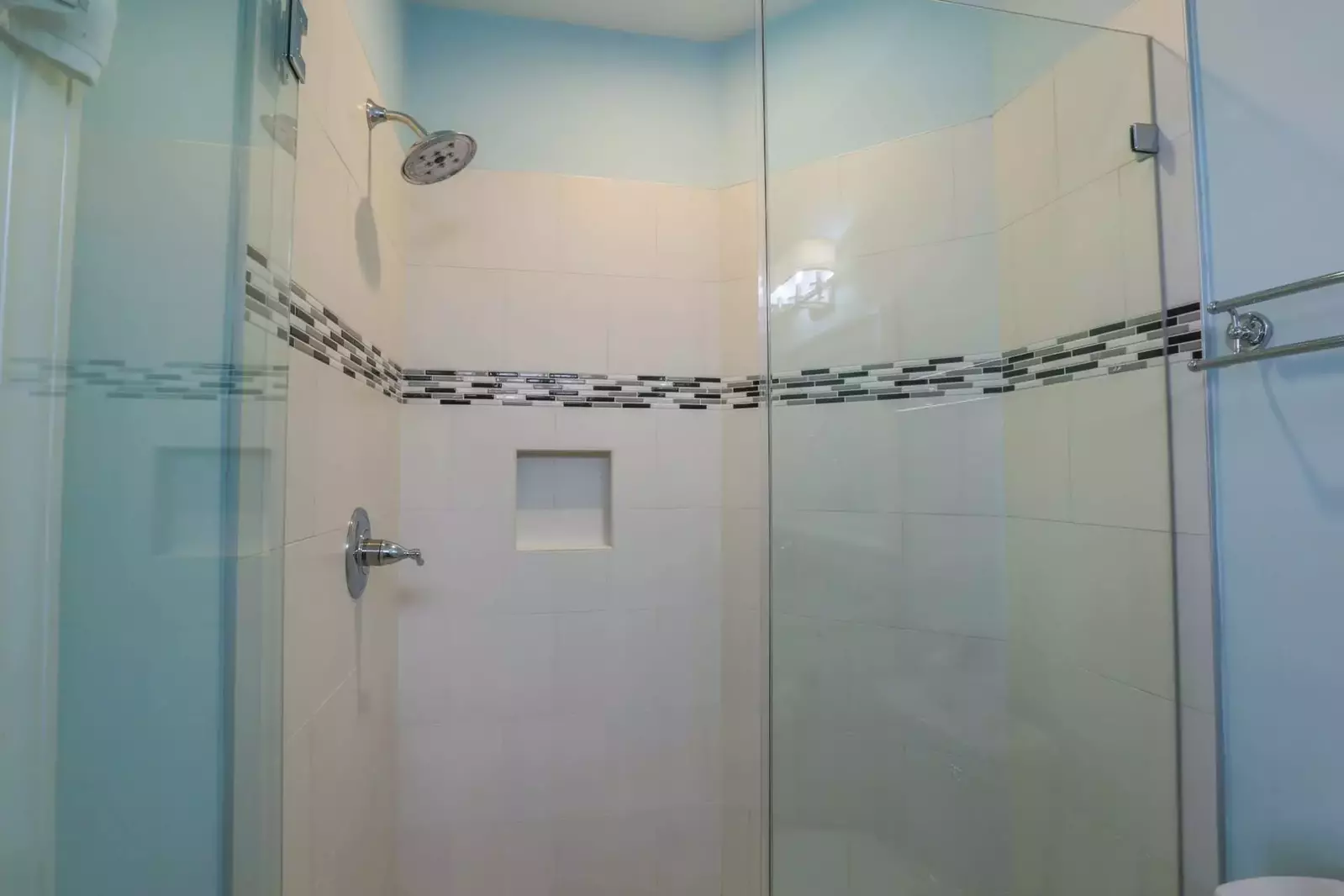 There's also a tiled walk-in shower with a rain showerhead.