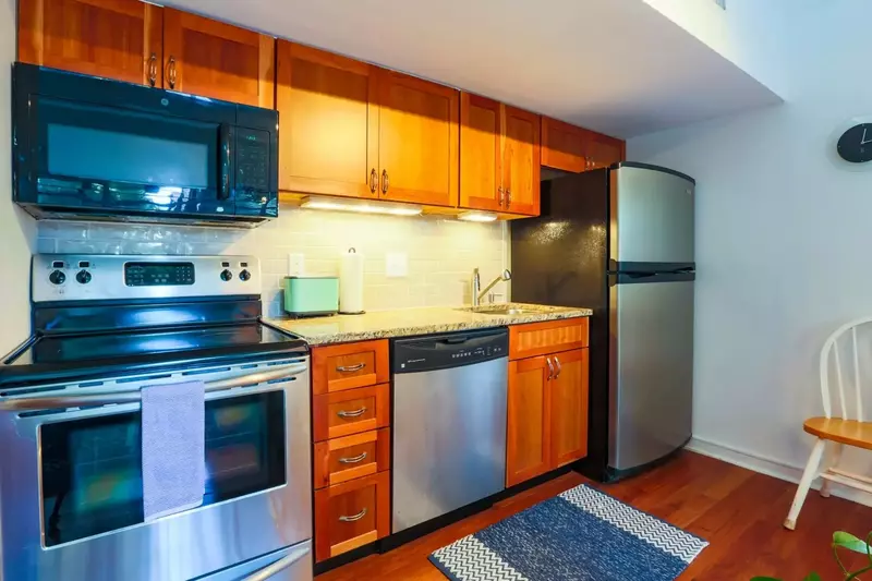 The kitchen features stainless steel appliances and granite countertops.