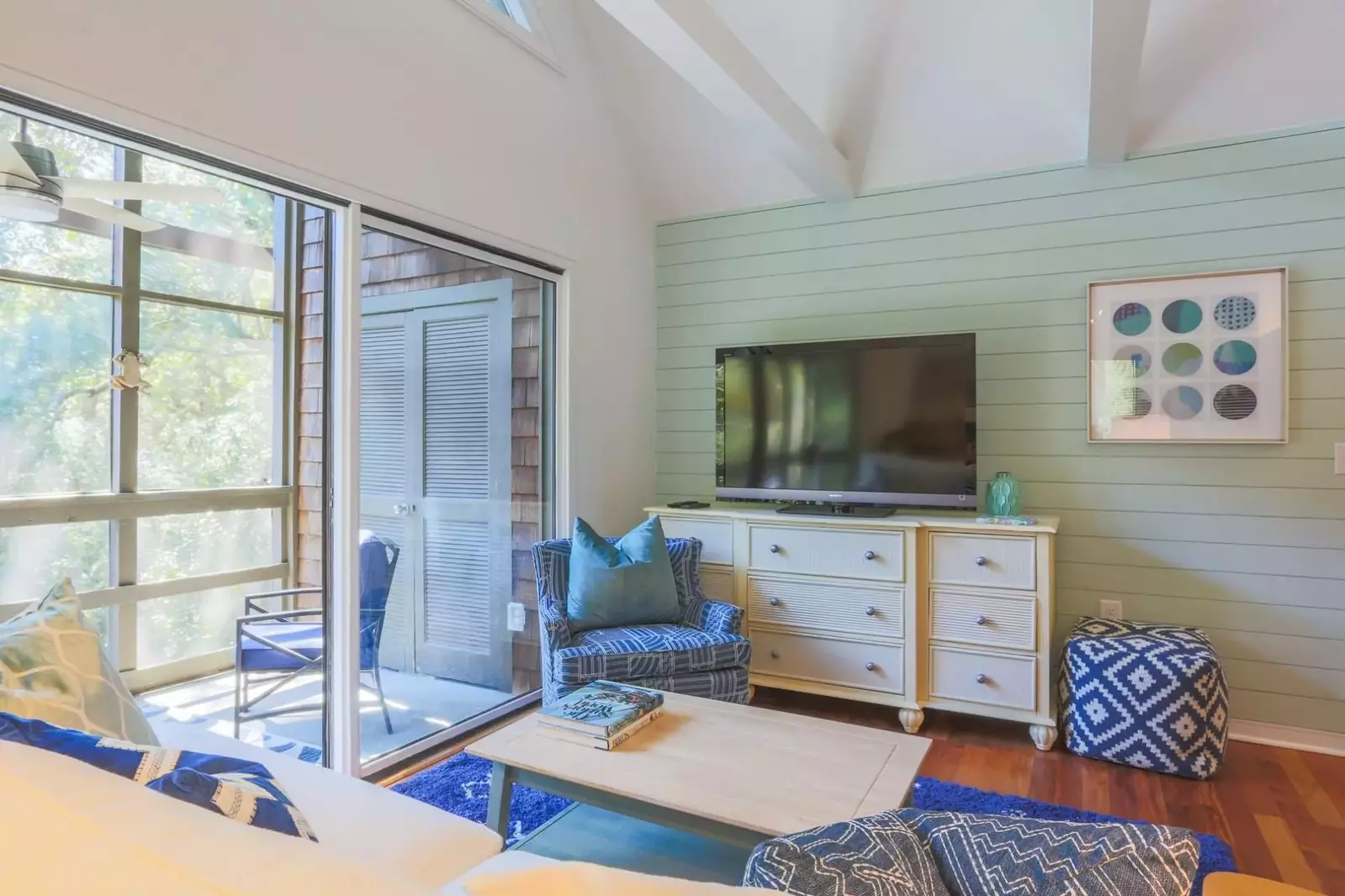 There's a large screen TV and comfortable seating area within the living room.