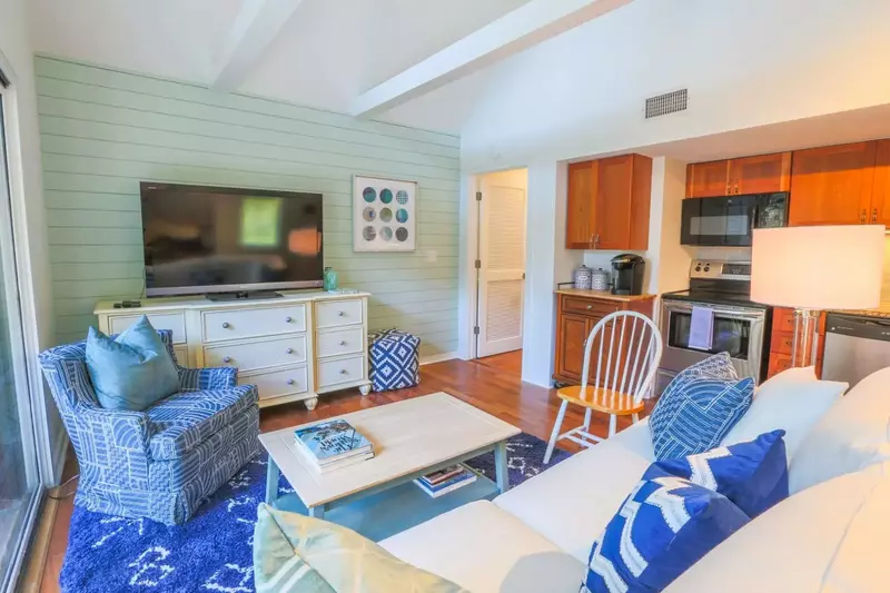 The white door in this photo leads to the bedroom, bathroom and front door.