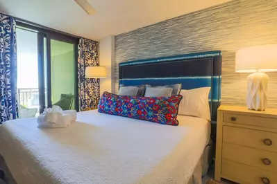 The master suite has a king bed and private access to the balcony.