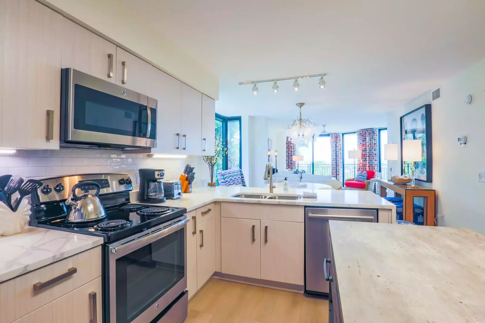 The kitchen features stainless steel appliances (range, dishwasher, microwave & refrigerator).