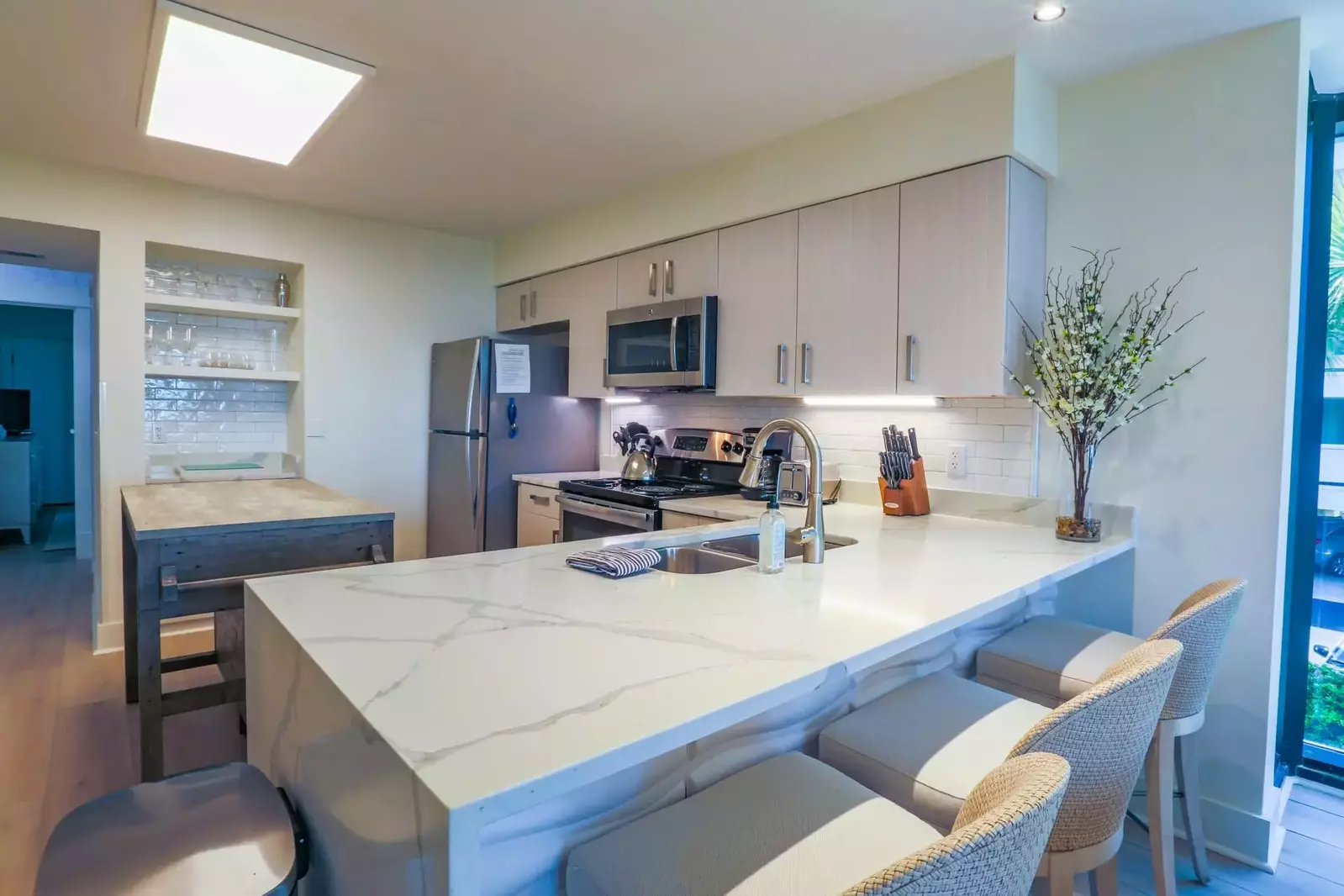 There are 3 stools alongside the kitchen counter.