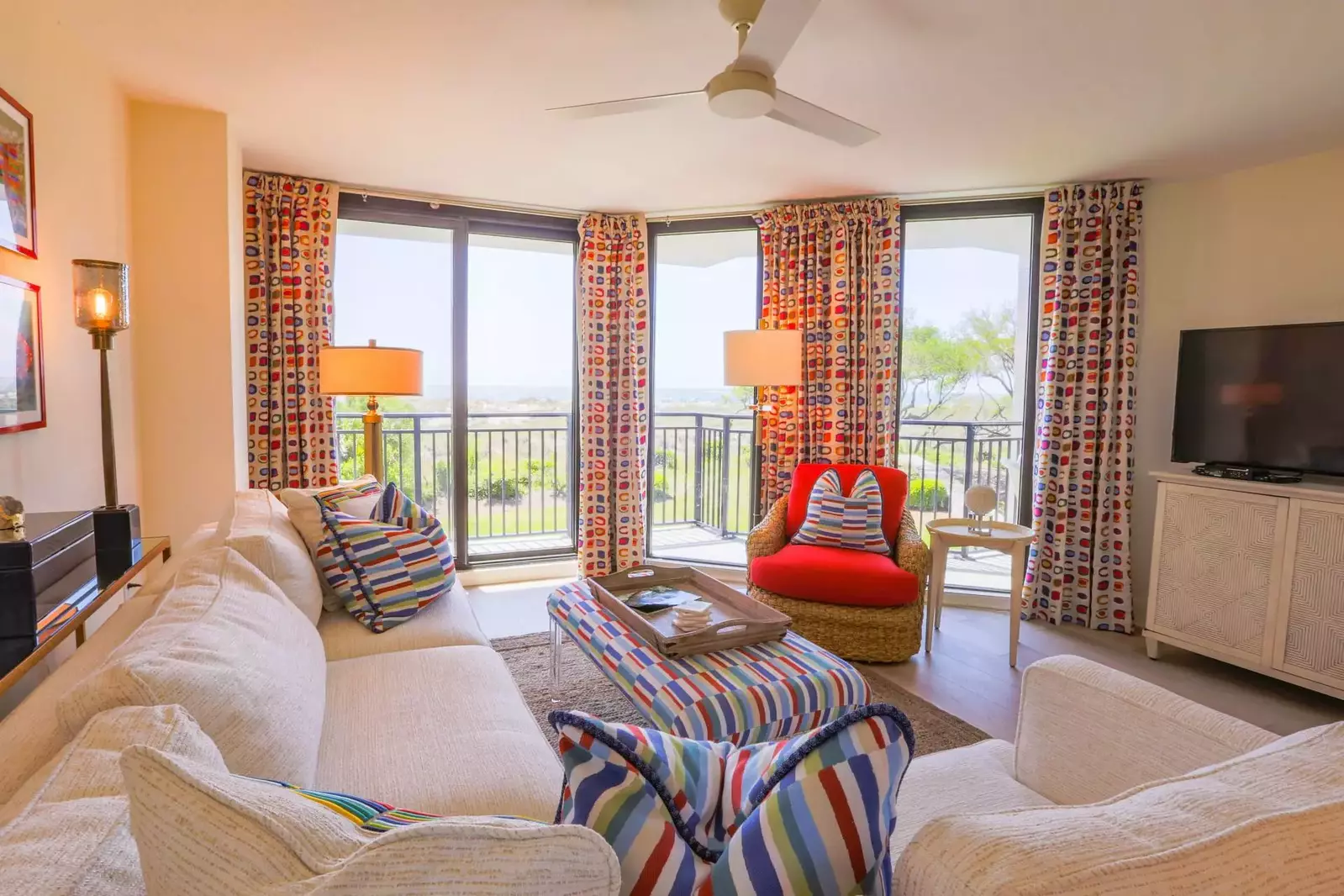 The living room features ocean views, a spacous sectional and sliding door access to the balcony.