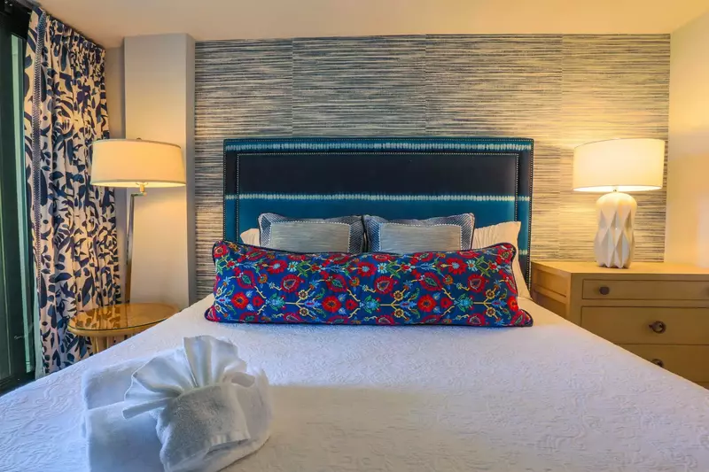 The master suite features a king bed and night stands with reading lamps.