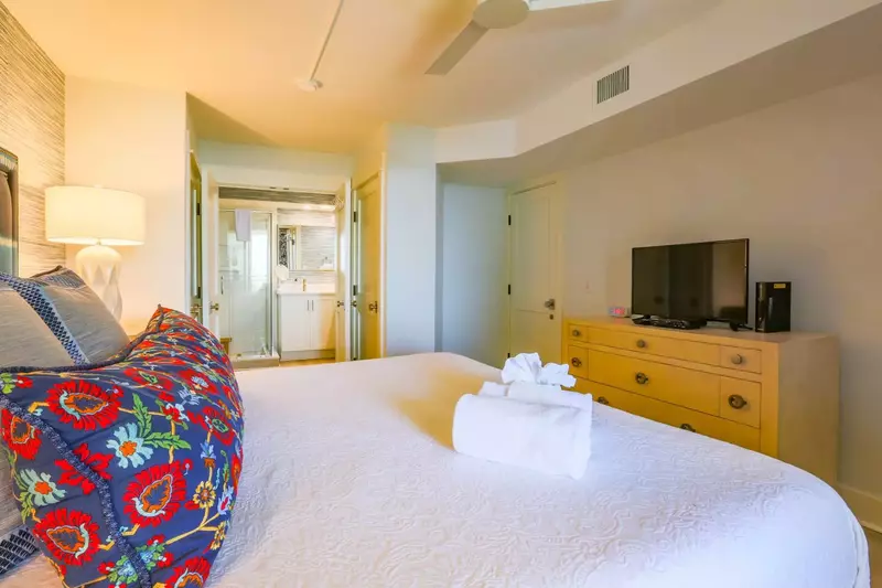The master suite also has a dresser, TV and an en suite bathroom.