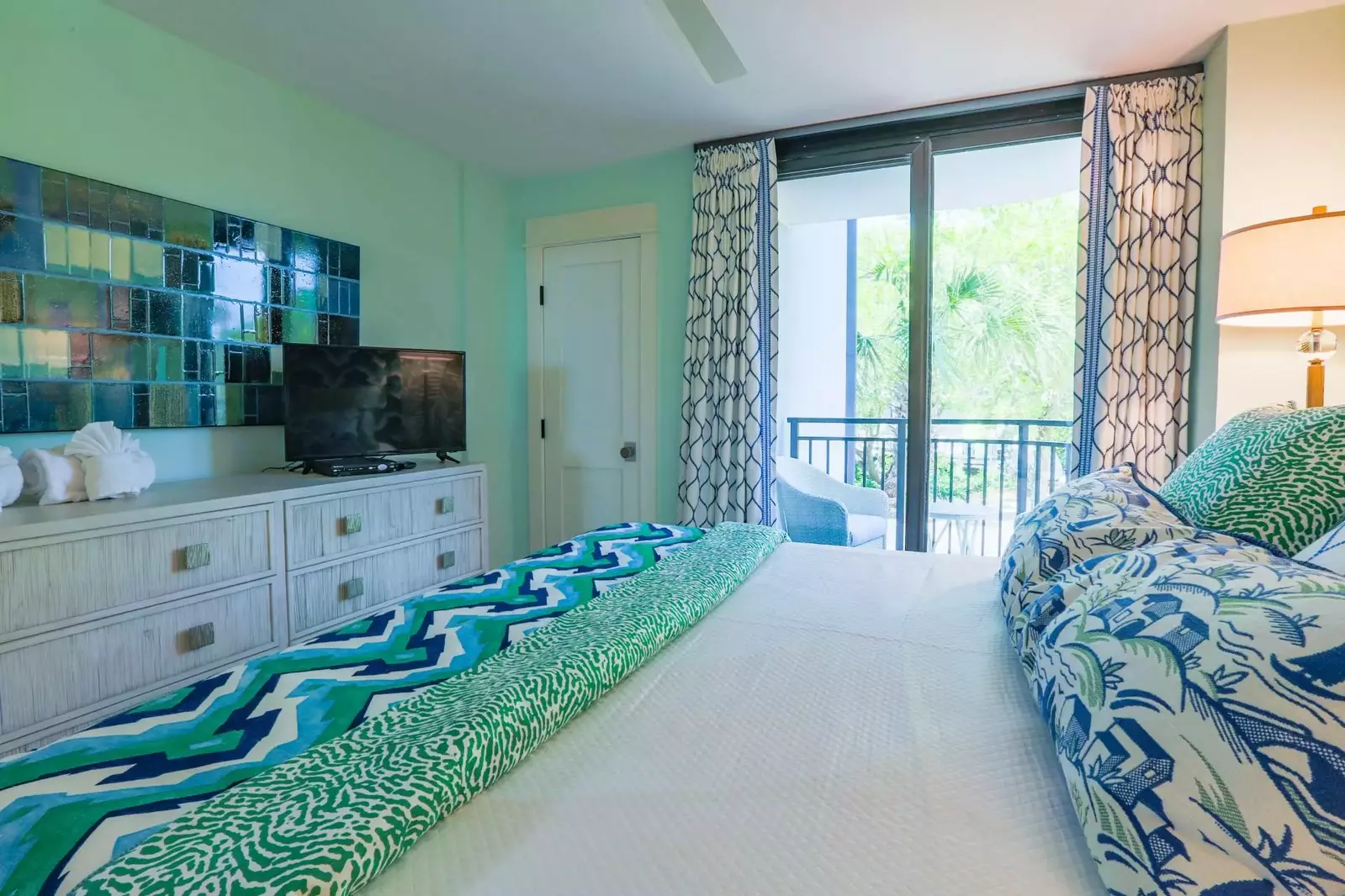 This guest bedroom also features a dresser and TV.