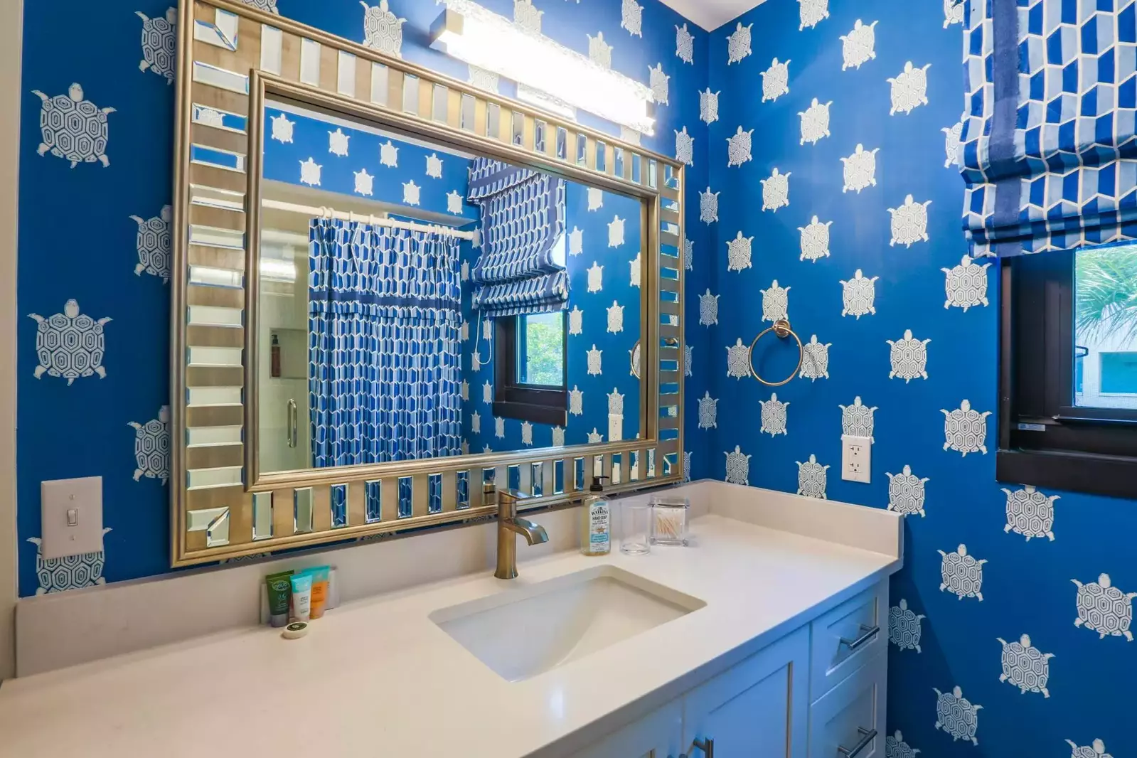 This renovated guest bathroom has a spacious vanity.
