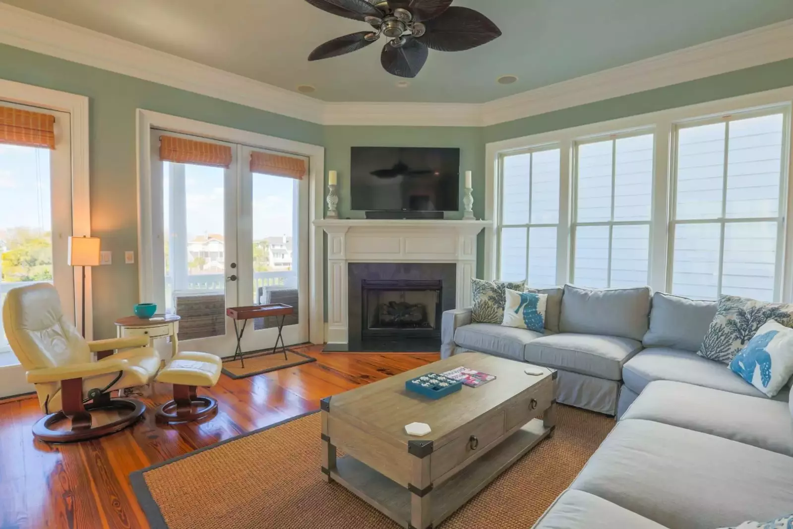 There's a covered porch that expands the full width of the house off the living room.