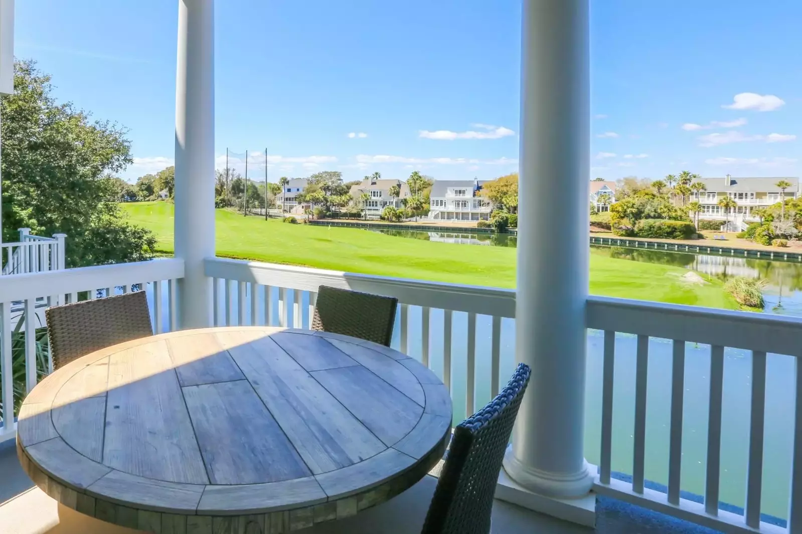 The covered porch has a dining table and four chairs.