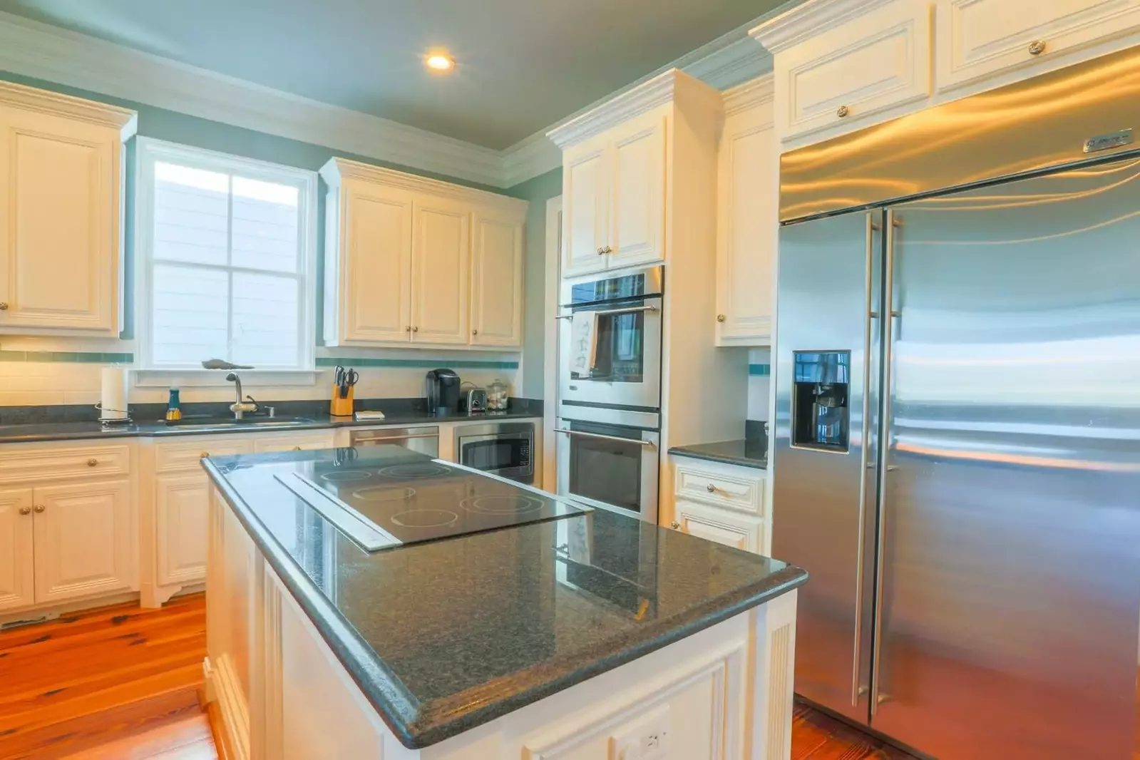 The kitchen has a double oven, electric cooktop, dishwasher and microwave.