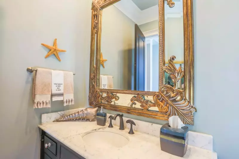 This half bathroom is located near the kitchen.