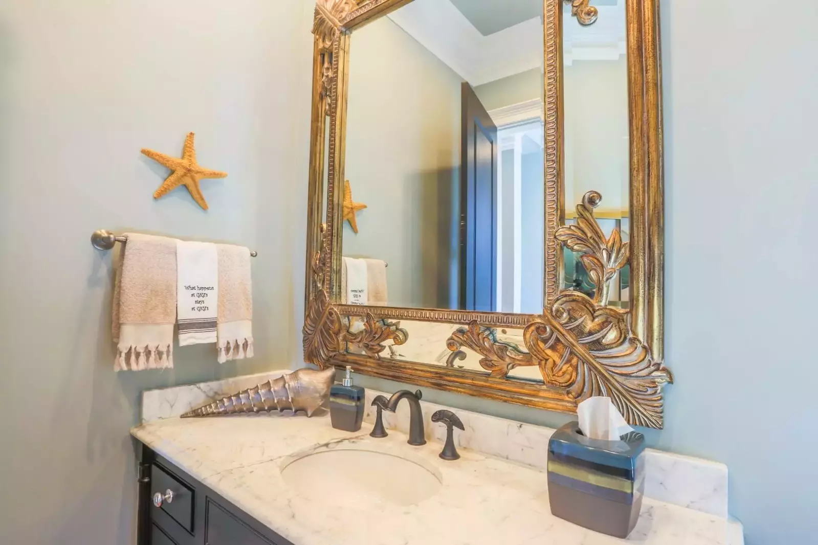 This half bathroom is located near the kitchen.