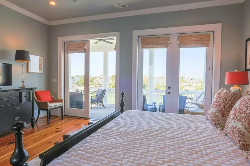 The master bedroom has a king bed, dresser with streaming TV and nightstands with reading lamps.