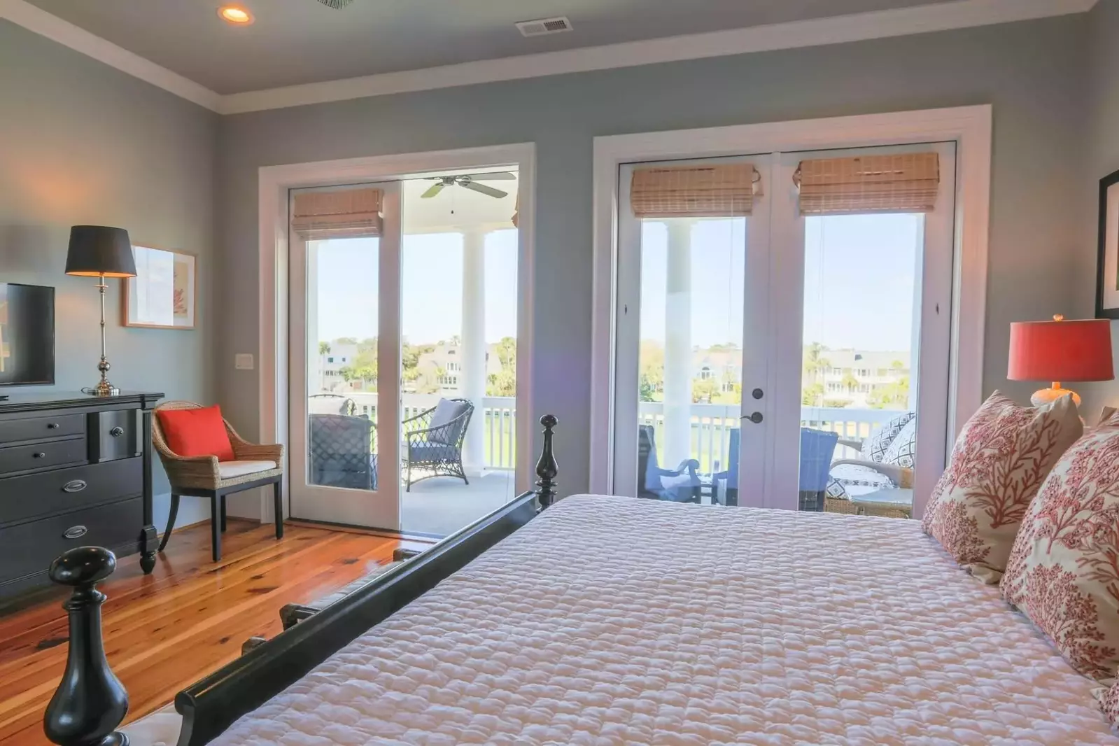 The master bedroom has a king bed, dresser with streaming TV and nightstands with reading lamps.