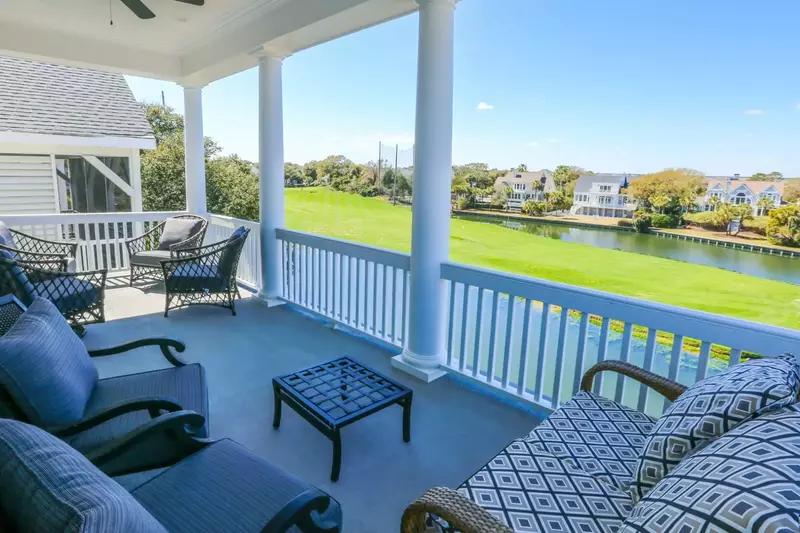The covered porch off of the master bedroom has two seating areas.
