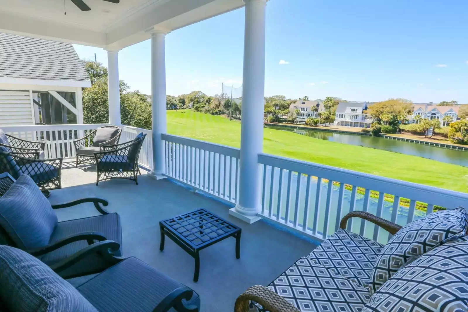 The covered porch off of the master bedroom has two seating areas.