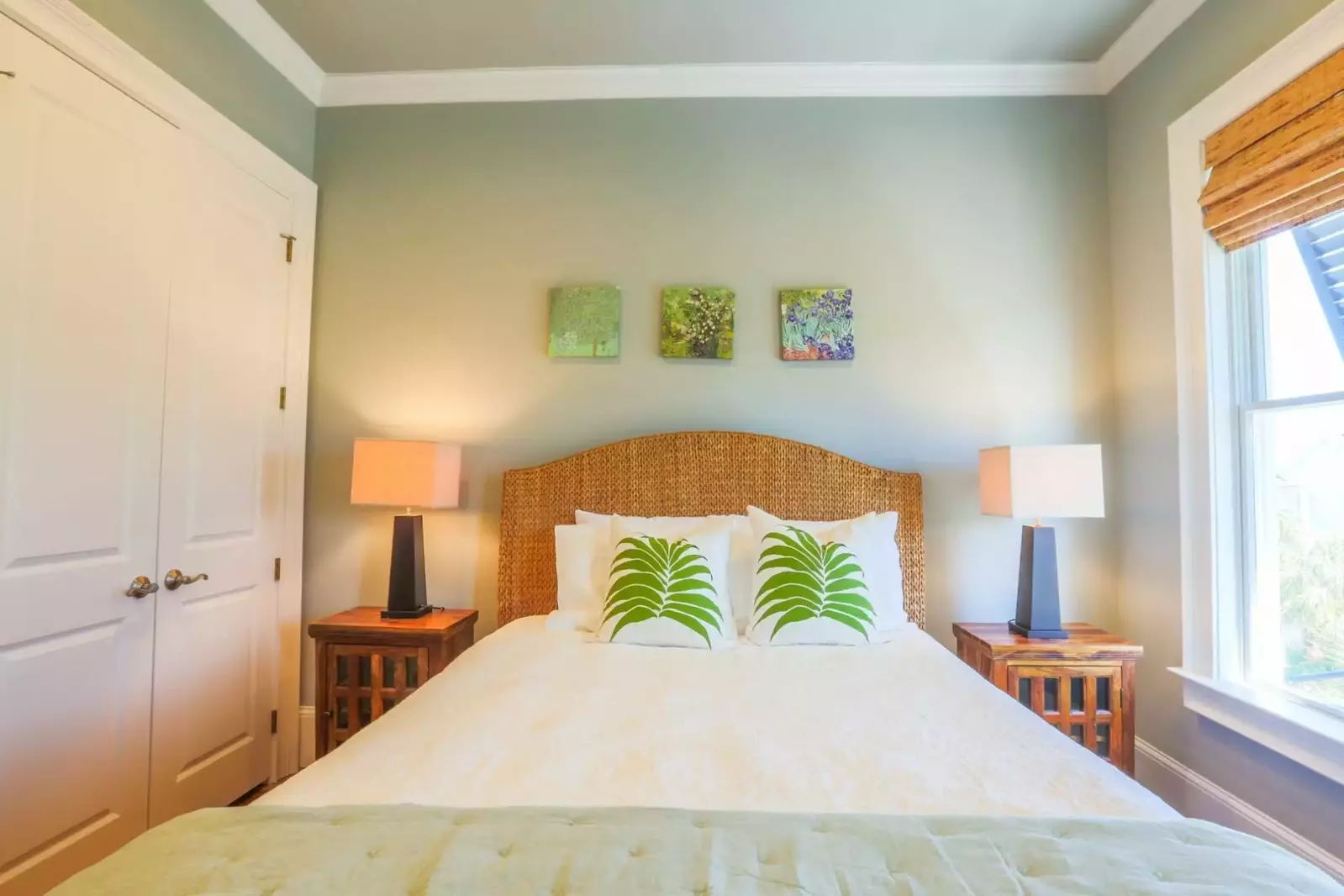 The queen bed is flanked by two nightstands with reading lamps.