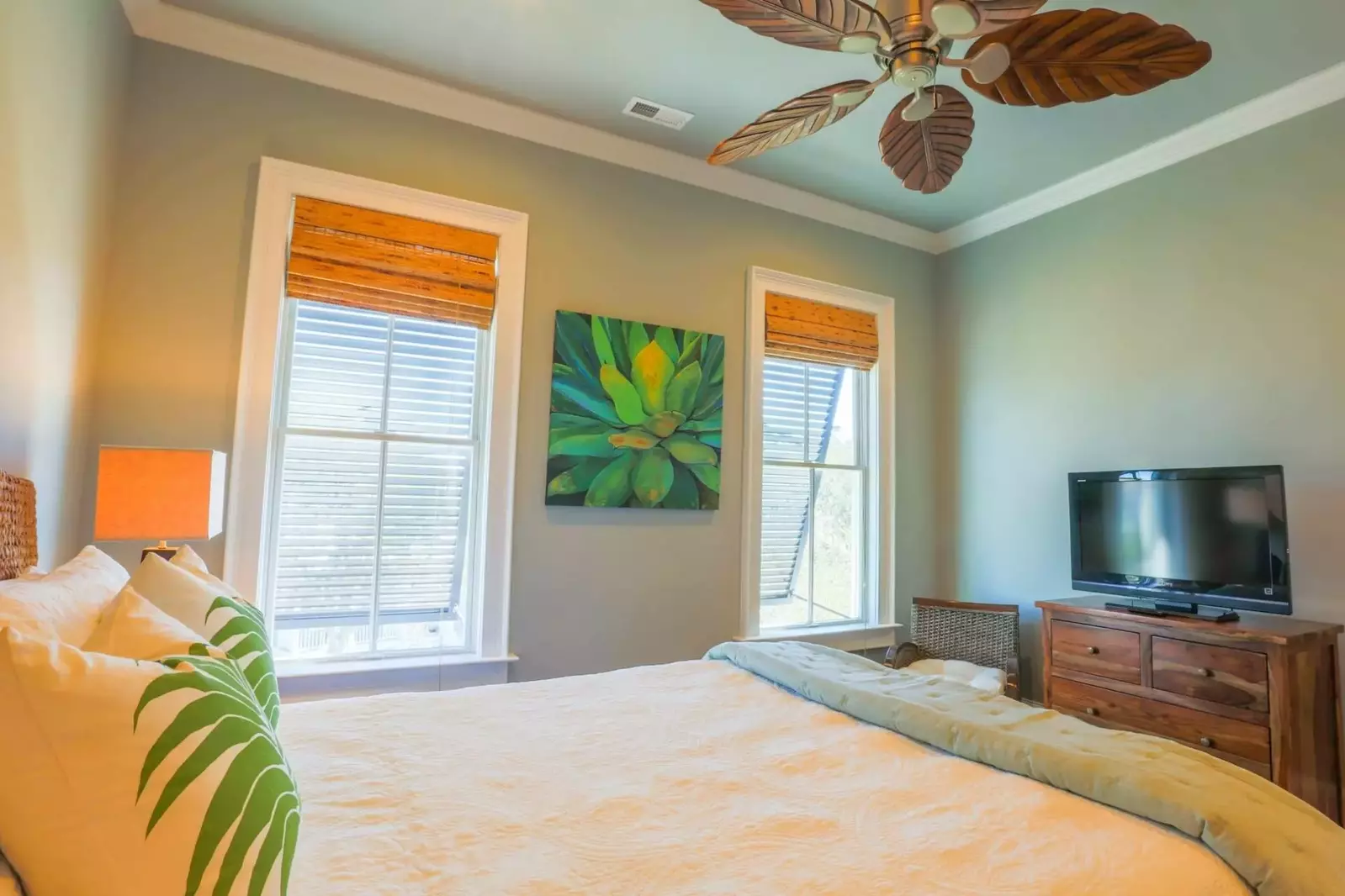 This second master suite also has a dresser with streaming TV and a ceiling fan.