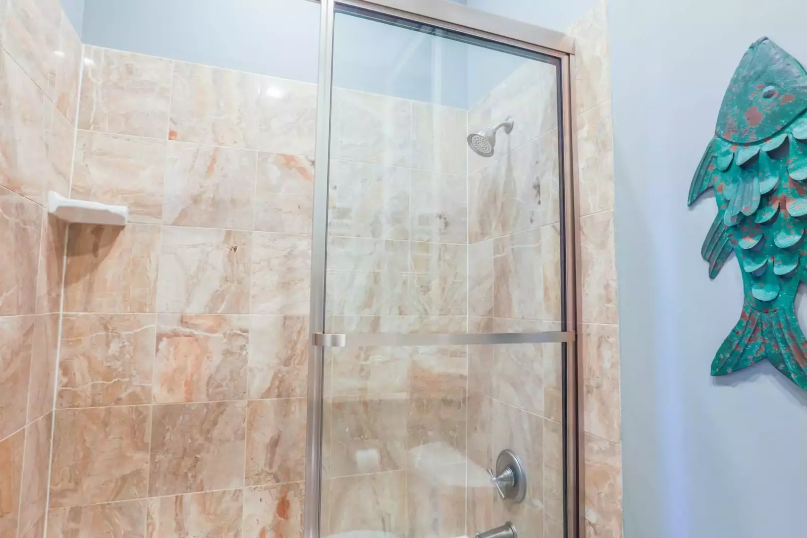 This en suite bathroom also has a tiled, walk-in shower.