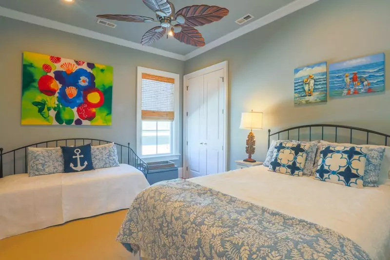 This guest bedroom, which is on the top floor of the home, features a queen bed and a day bed.