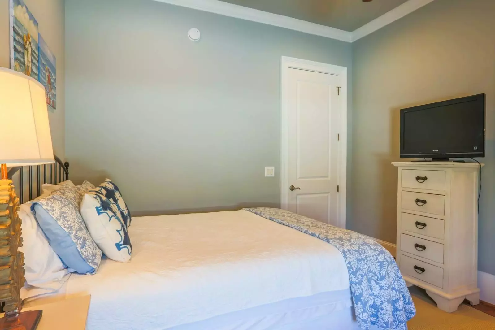 This guest bedroom also has a dresser with a streaming TV.