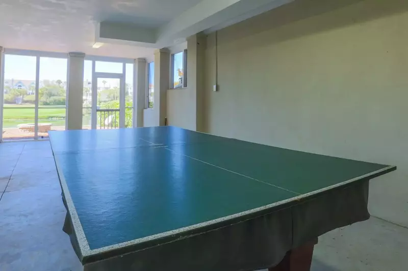 The ground floor of Gigi's Beach House features a game table that can be used for ping pong or billiards.