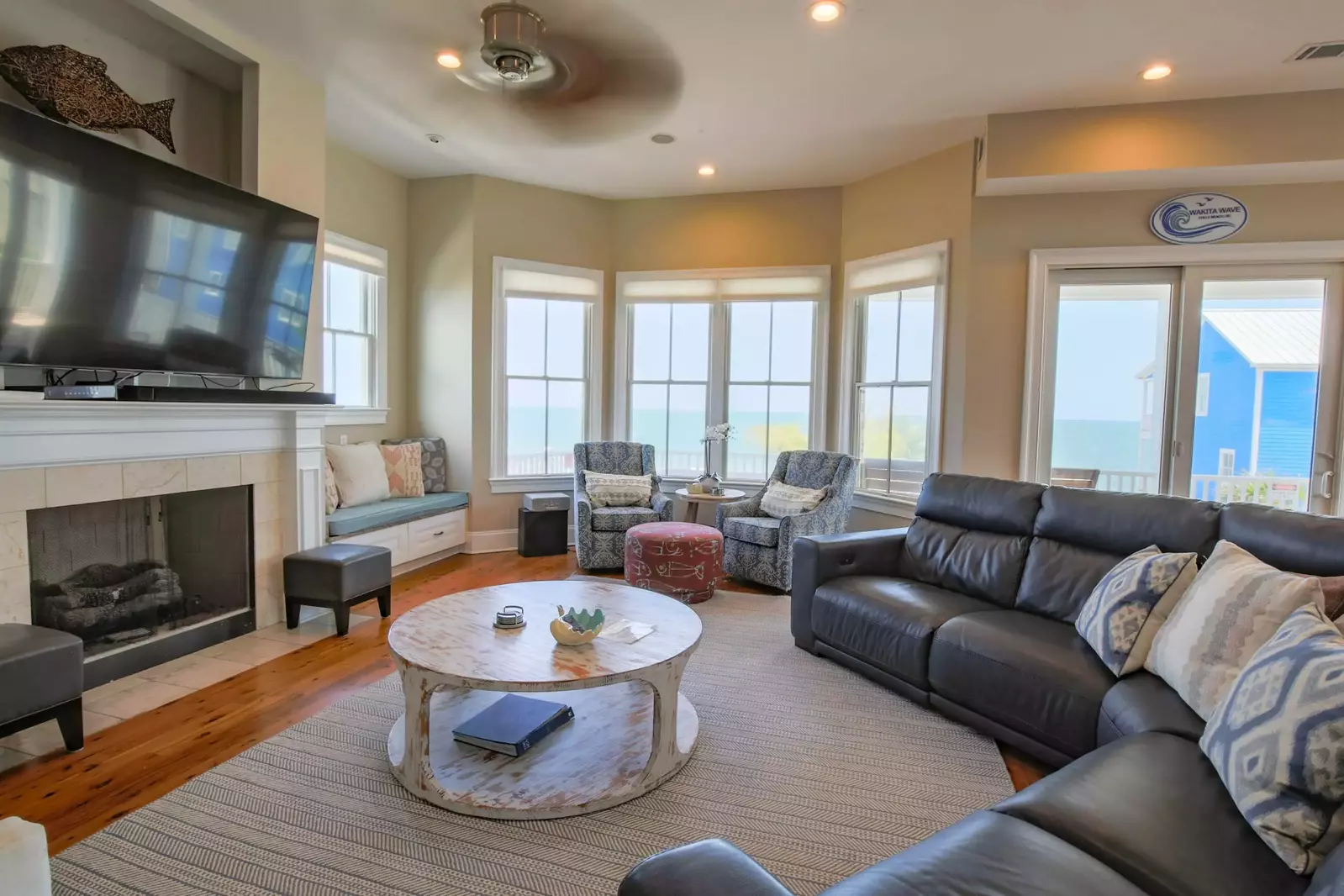 The spacious seating area in the living room is centered the large screen TV.