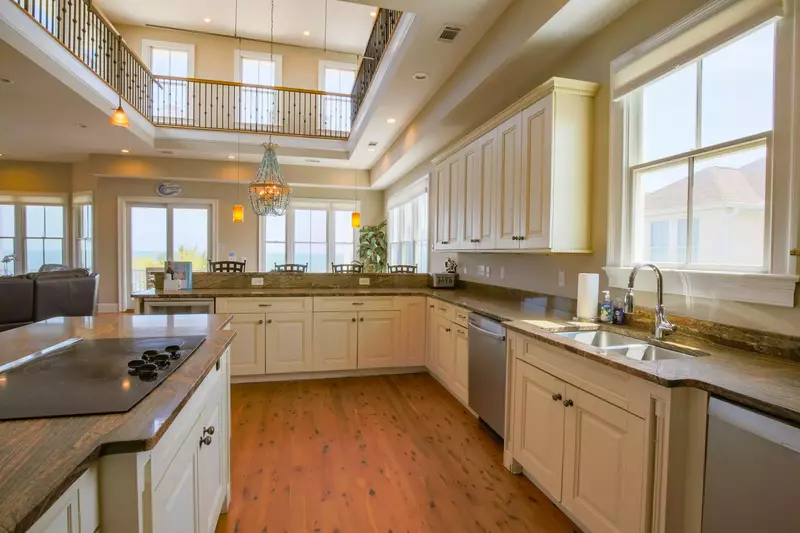 The kitchen features two dishwashers, an electric cooktop, wine refrigerator and microwave.