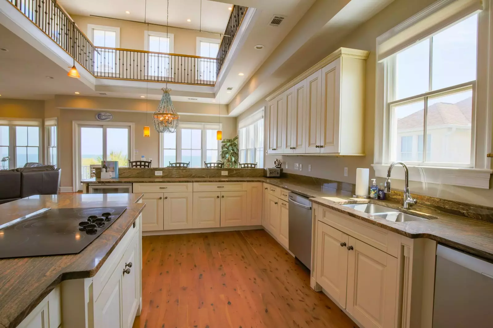 The kitchen features two dishwashers, an electric cooktop, wine refrigerator and microwave.
