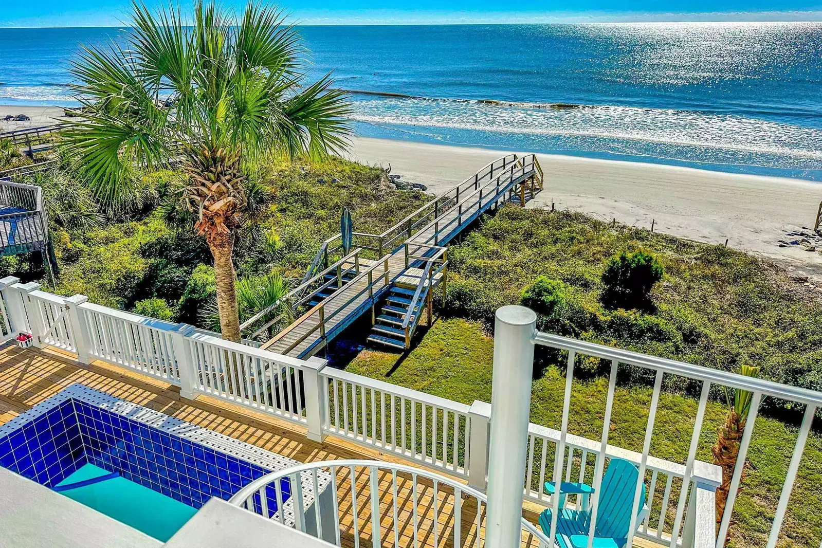 This covered porch off of the kitchen connects to the pool deck via the exterior spiral staircase.