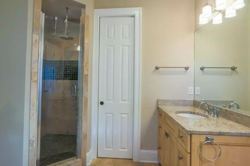 The en suite bathroom for the master suite has a walk-in shower with rain and handheld showerheads.