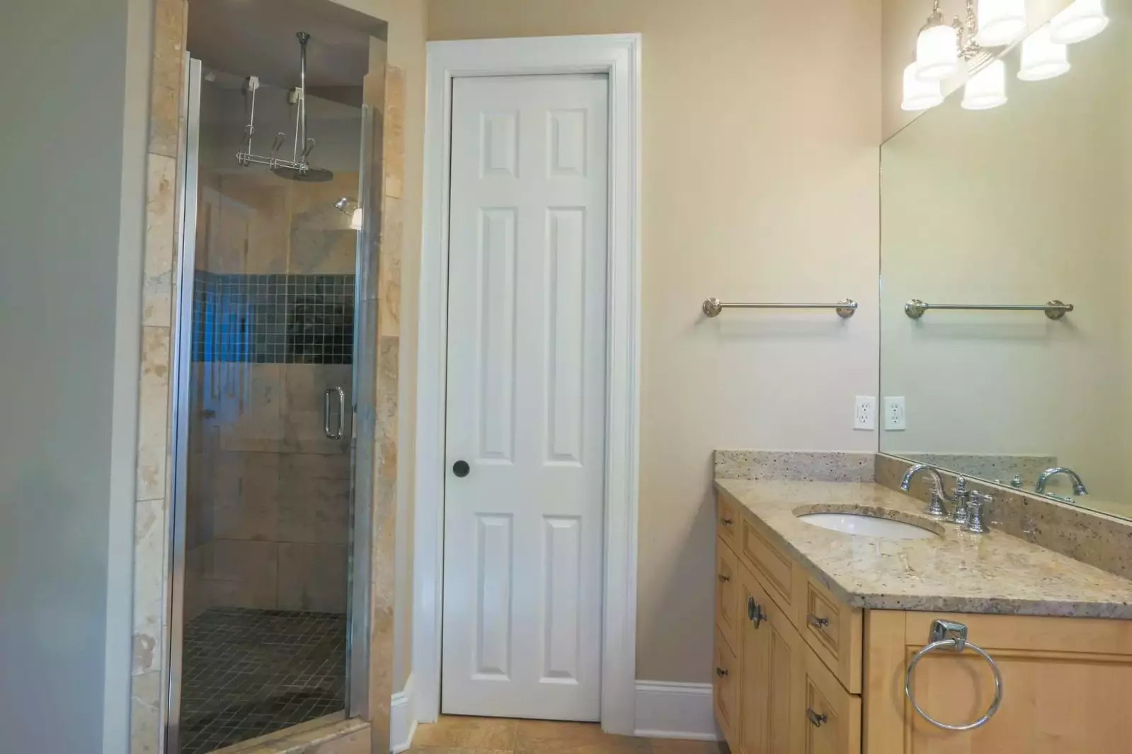 The en suite bathroom for the master suite has a walk-in shower with rain and handheld showerheads.