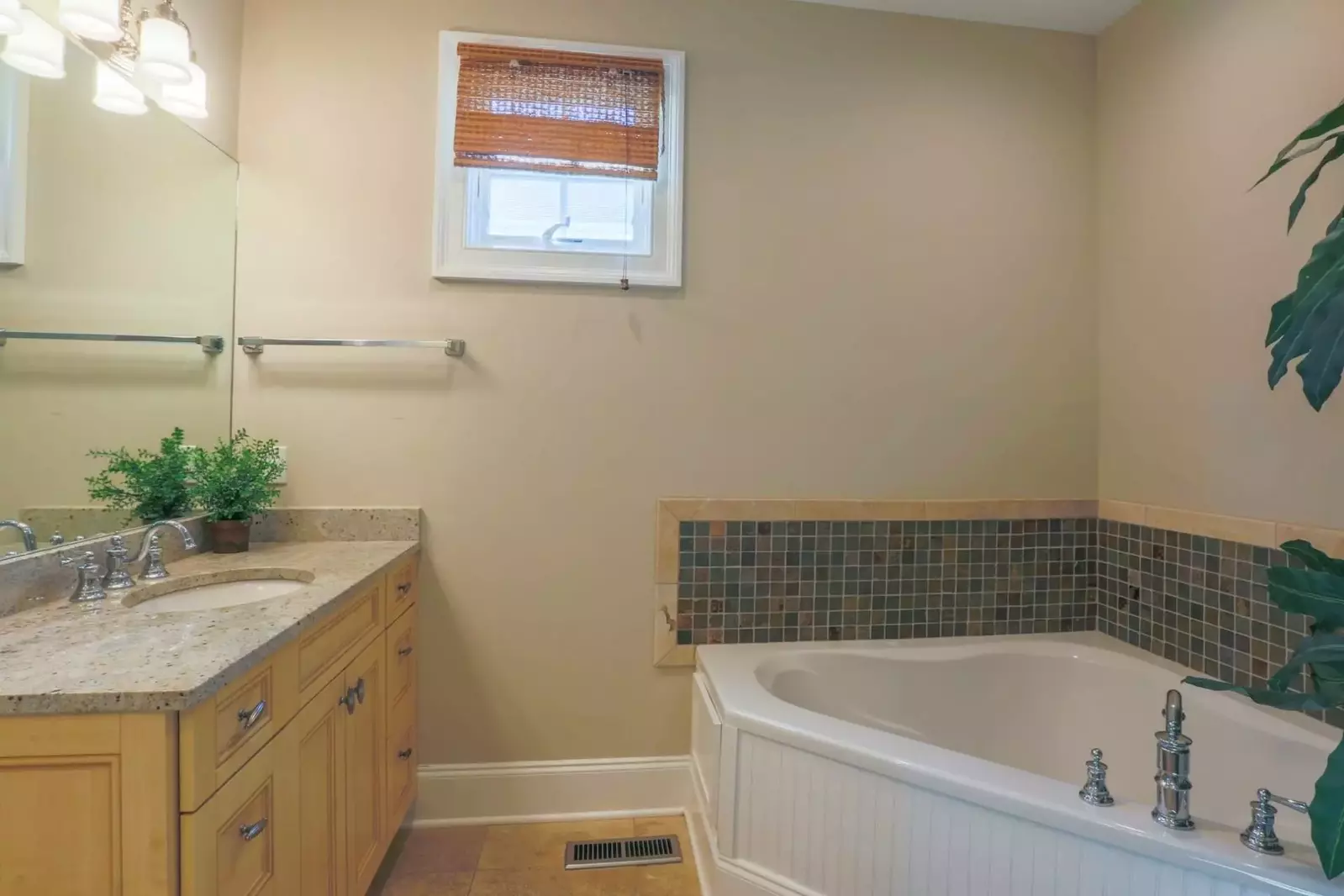 The en suite bathroom for the master suite also has a corner soaking tub and two separate vanities.
