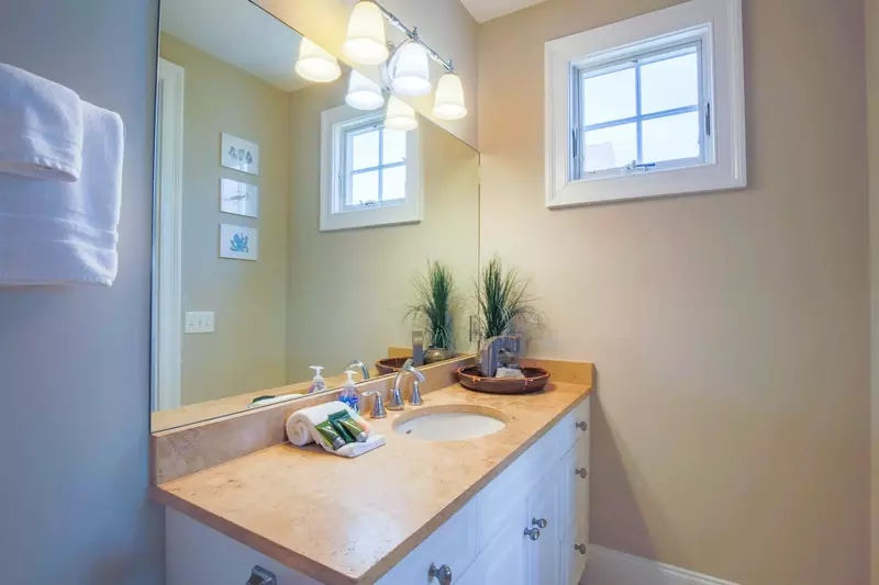 This en suite bathroom features a spacious vanity and a walk-in shower.