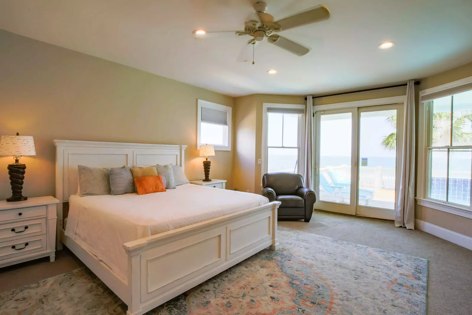 This king bedroom features ocean views and sliding door access to the pool deck.
