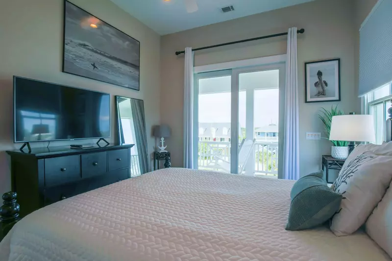 This room features a queen bed, en suite bathroom and sliding door access to the front porch.