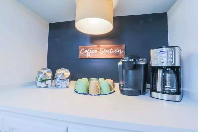 The coffee station in the kitchen has both a keurig and a drip coffee maker.
