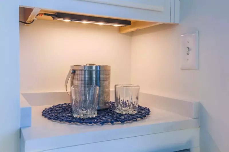 There's a wine refrigerator and mini bar area in the living room.