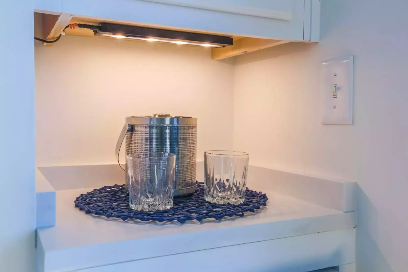 There's a wine refrigerator and mini bar area in the living room.
