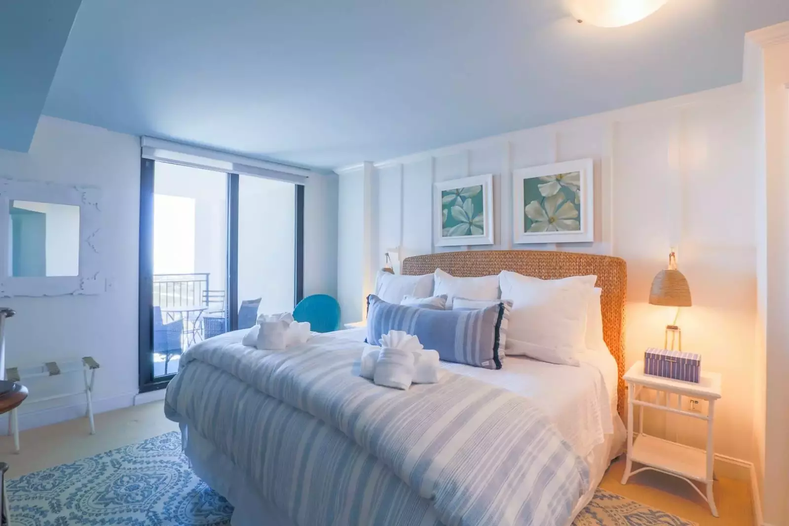 The master bedroom suite features a king bed and night stands with reading lamps.