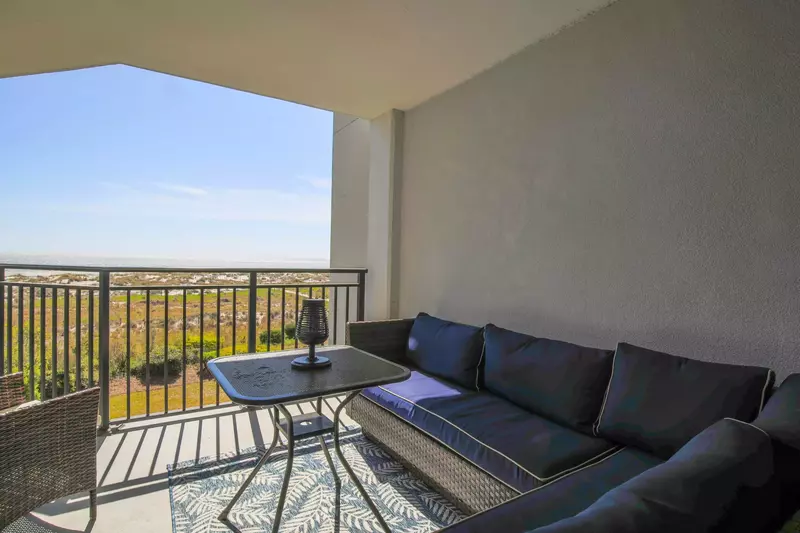 Walk through the sliding glass doors in the master bedroom and relax in this seating area on the balcony.