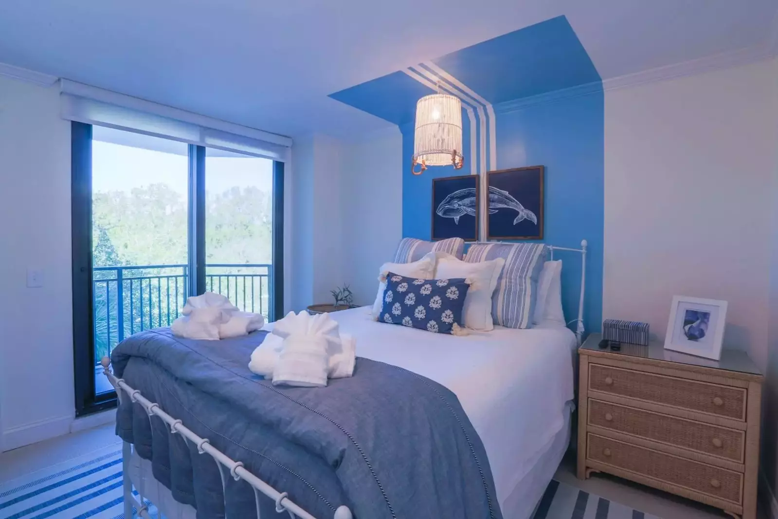 This guest bedroom has a queen bed, night stands and a reading lamp.