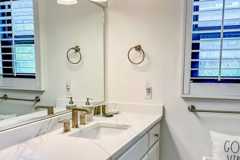 The renovated en suite bathroom for the queen bedroom features a spacious vanity.