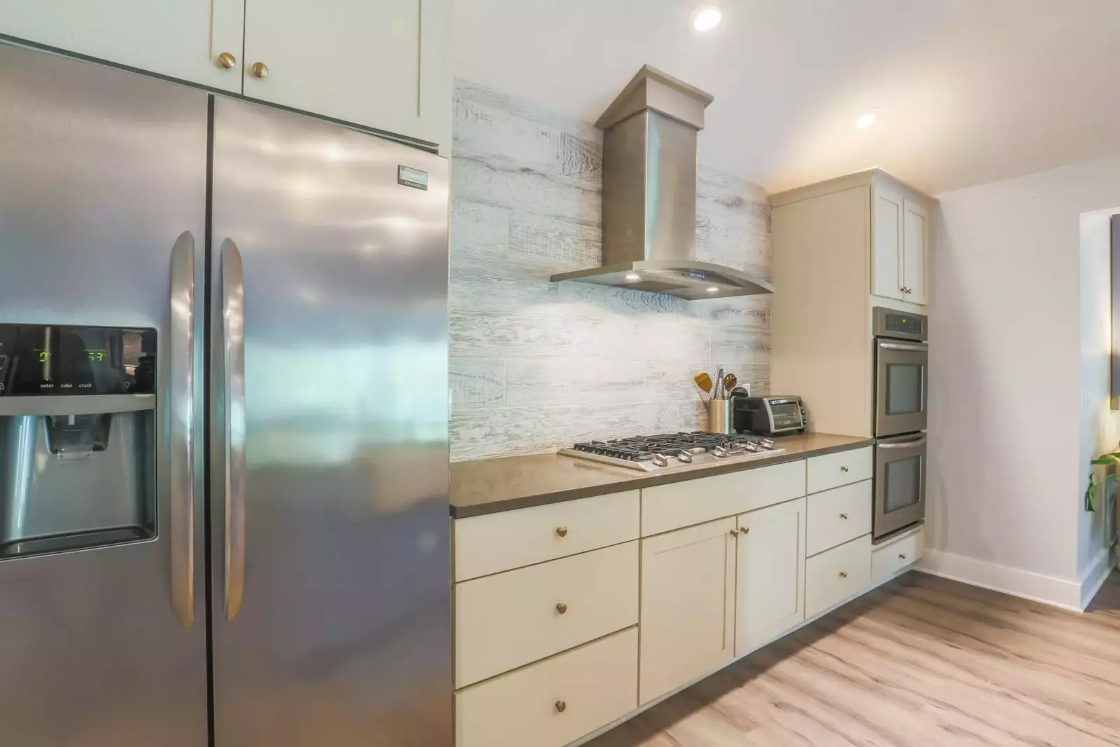 There is an oven, microwave, gas cook top, two refrigerators and a toaster oven.