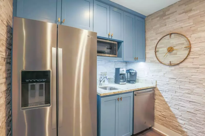 The home's second refrigerator, second dishwasher, wet bar, microwave and coffee station are located near the kitchen.