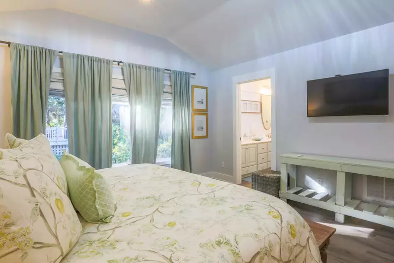 There is also a mounted smart TV and en suite bath in this master suite.