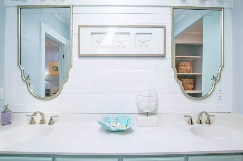 The beautifully renovated master bathroom features a double sink vanity.