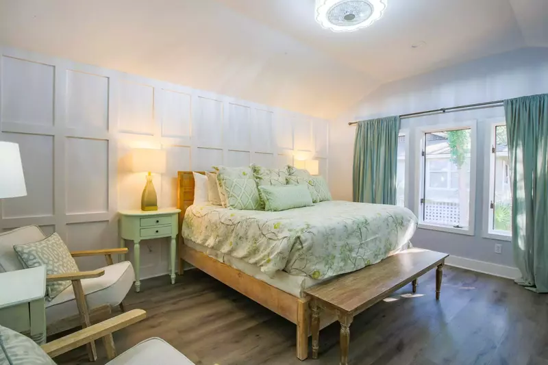 This master suite features a king bed and two night stands with reading lamps.