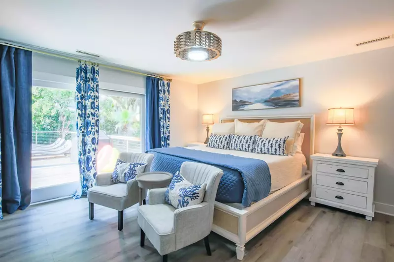 The home's second master suite has sliding door access to the back sun deck & pool area.